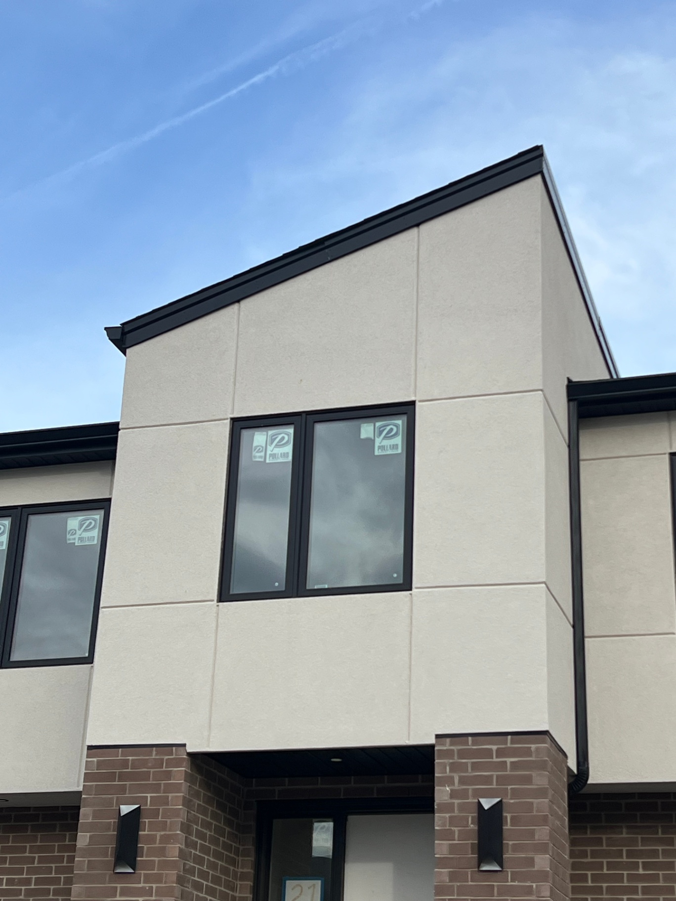 Modern beige stucco elevation with clean panelized reveal detailing
