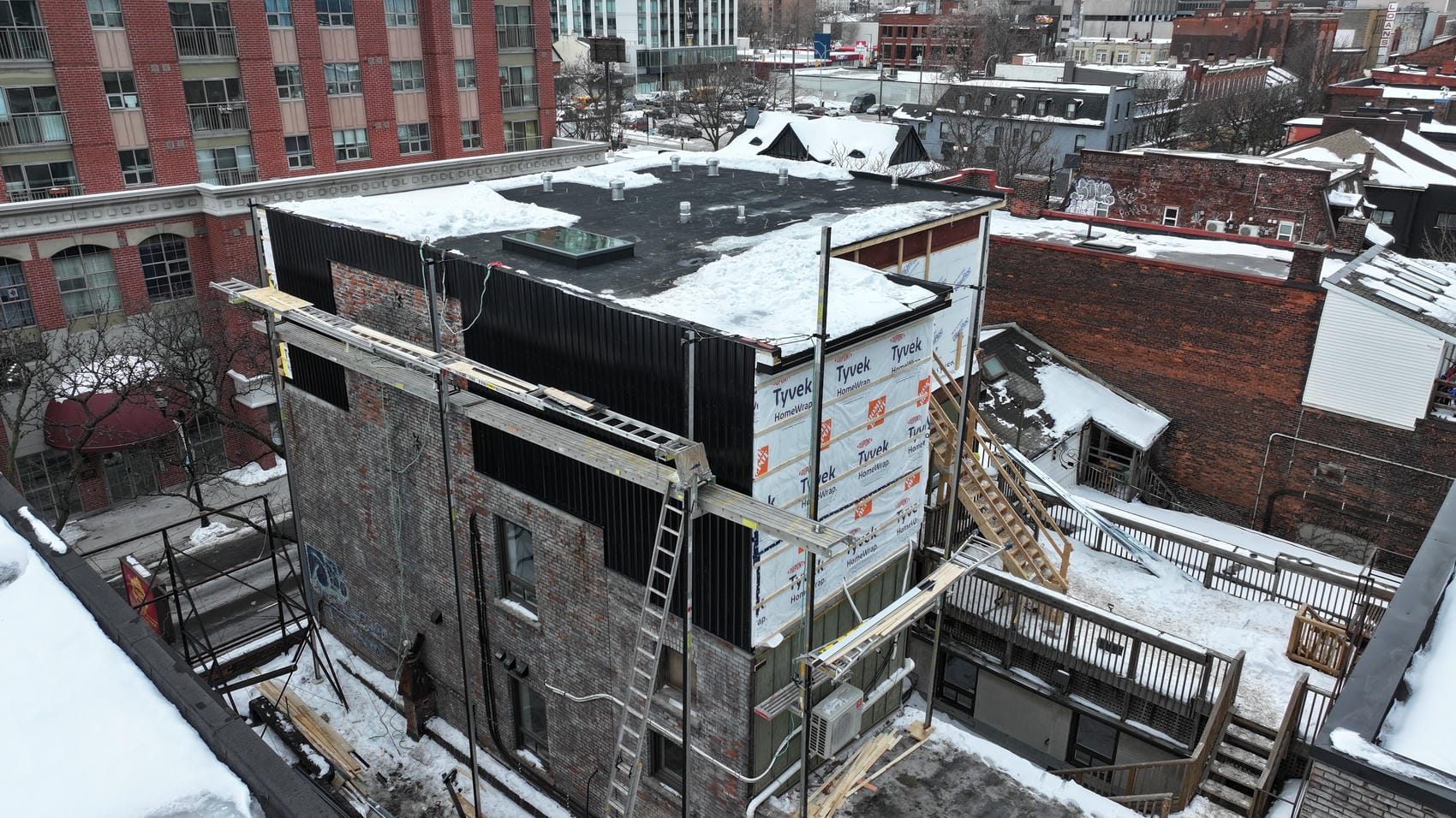 Commercial exterior renovation with Tyvek wrap and aluminum siding in Hamilton