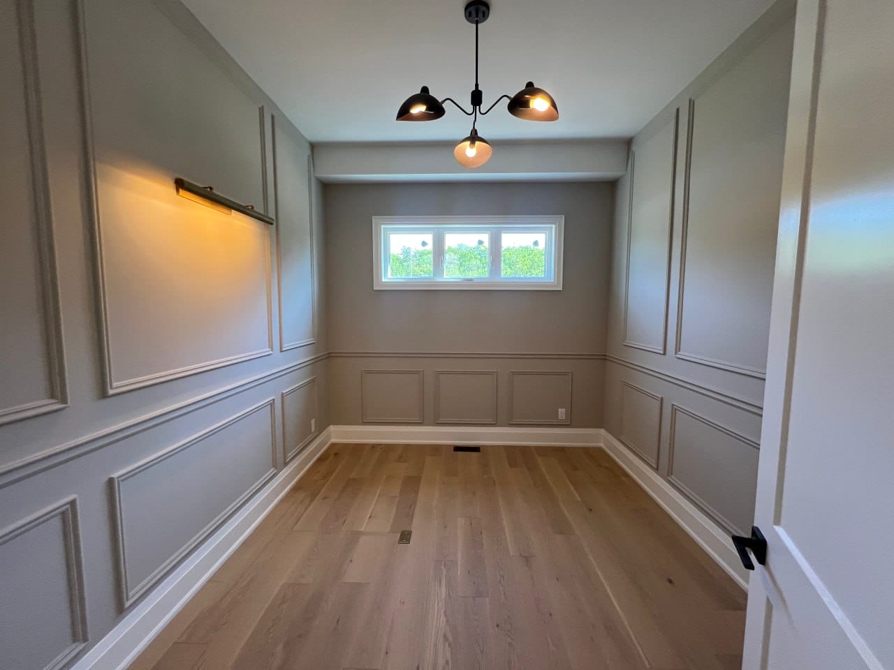 Grimsby interior renovation — dining room with wainscoting trim detail and modern lighting