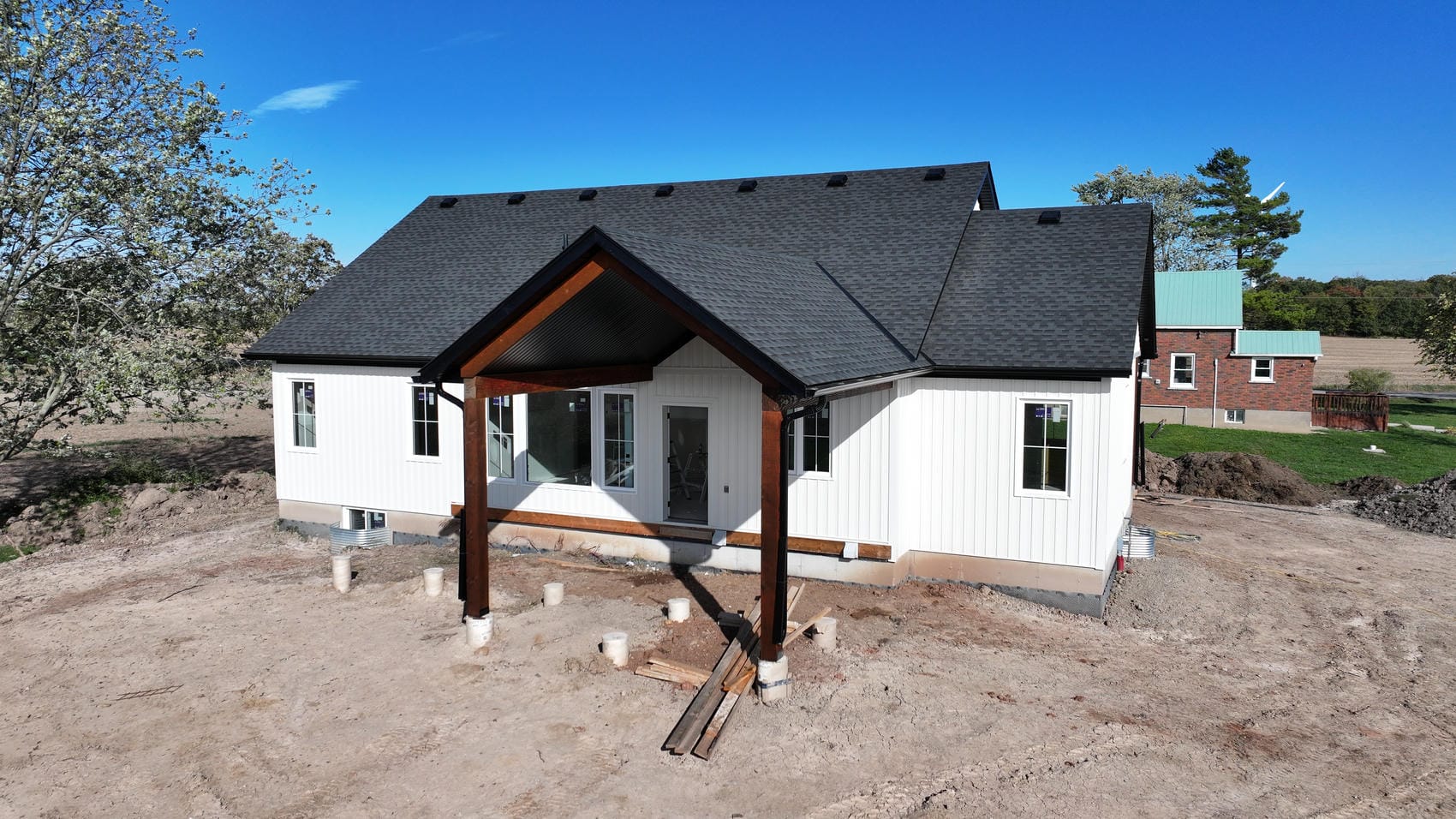 Covered porch detail with white board and batten siding on Grimsby new build exterior