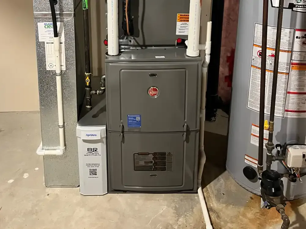 Newly installed Rheem furnace with humidifier and filter cabinet beside the water heater