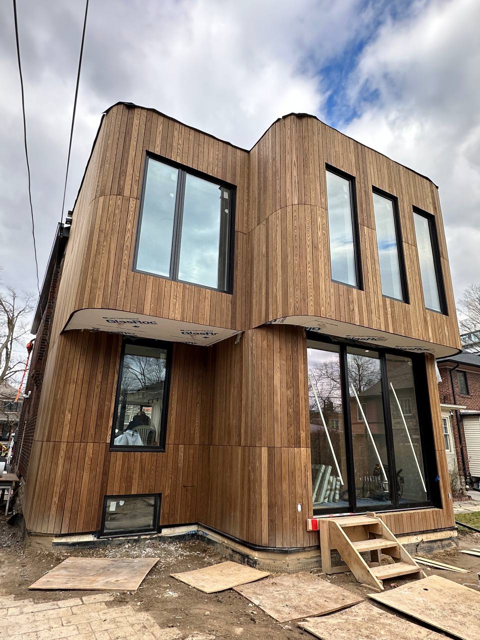 Luxury wood siding renovation with rounded corner details in Niagara Region