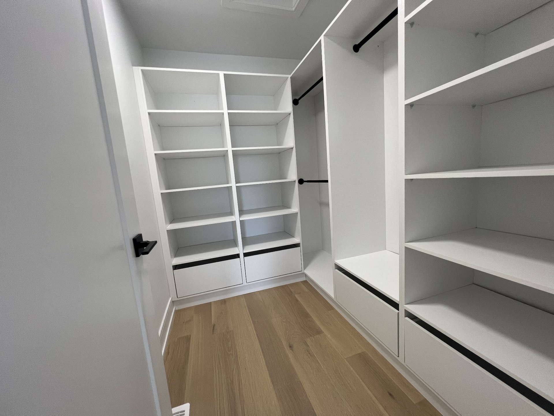 Niagara Falls interior renovation — custom walk-in closet with built-in shelving and hanging rods