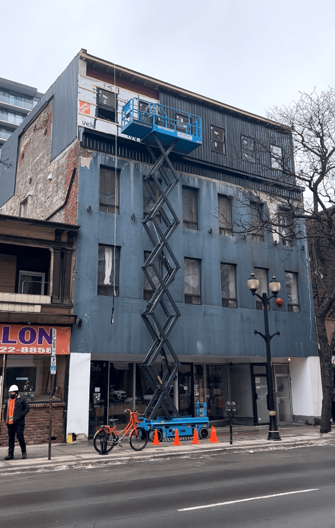 Commercial aluminum siding installation progress on Hamilton building