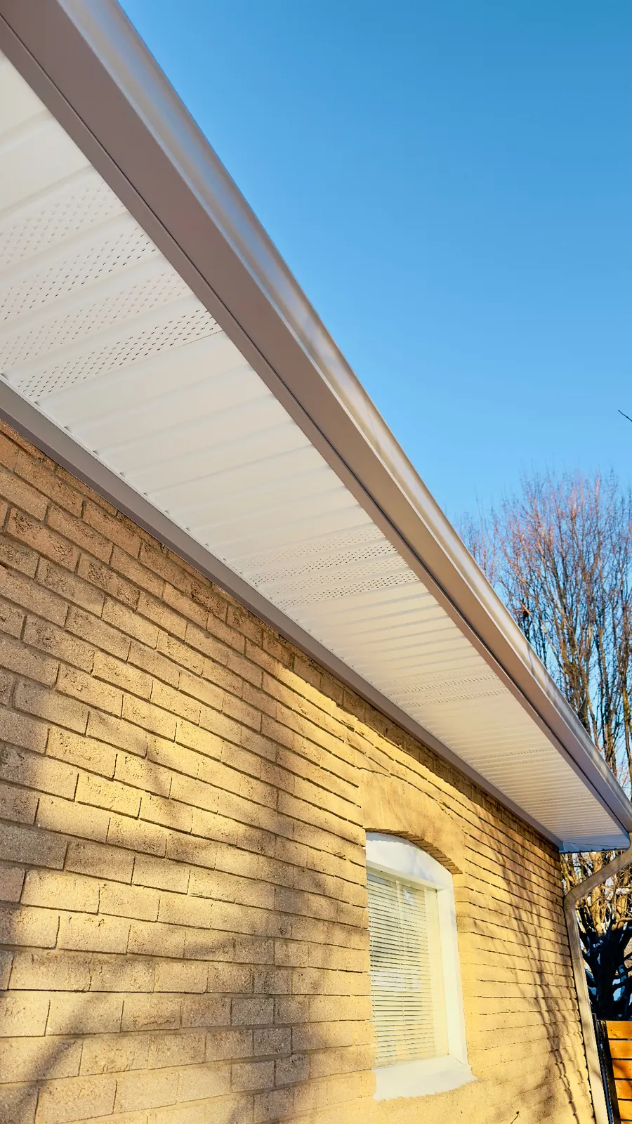 Vented aluminum soffit panel with matching fascia