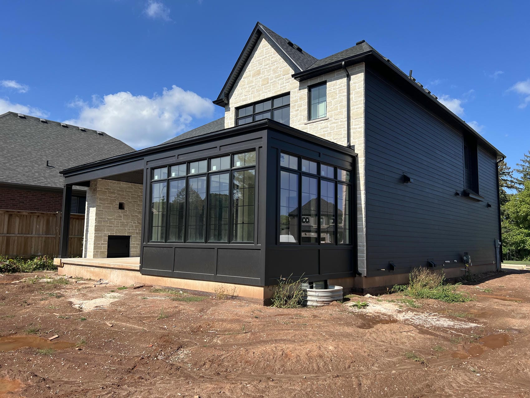 Custom panel and trim siding on rear sunroom in Stoney Creek