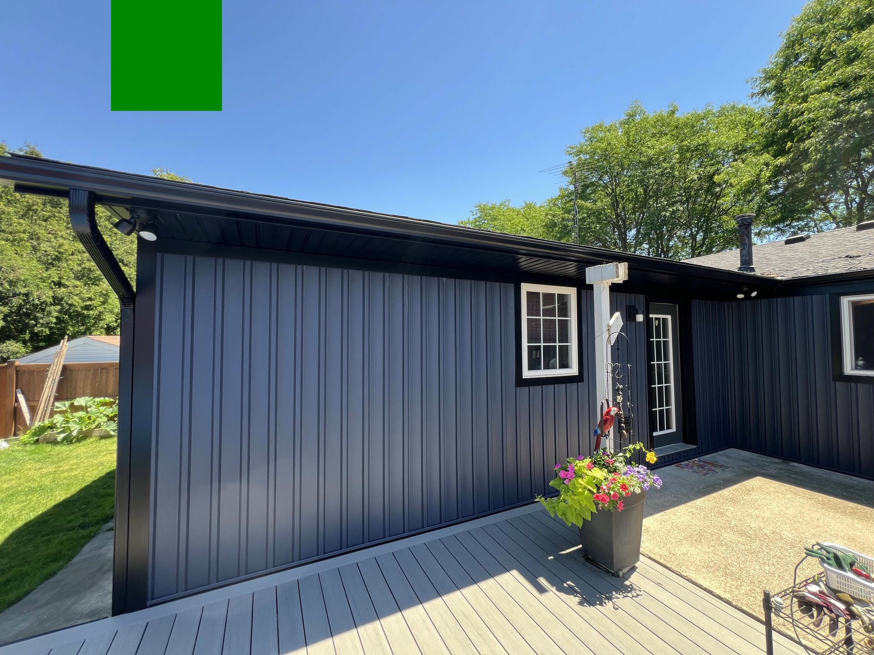 Blue vinyl board and batten siding installed by Renovation Xperts Group in Niagara Falls