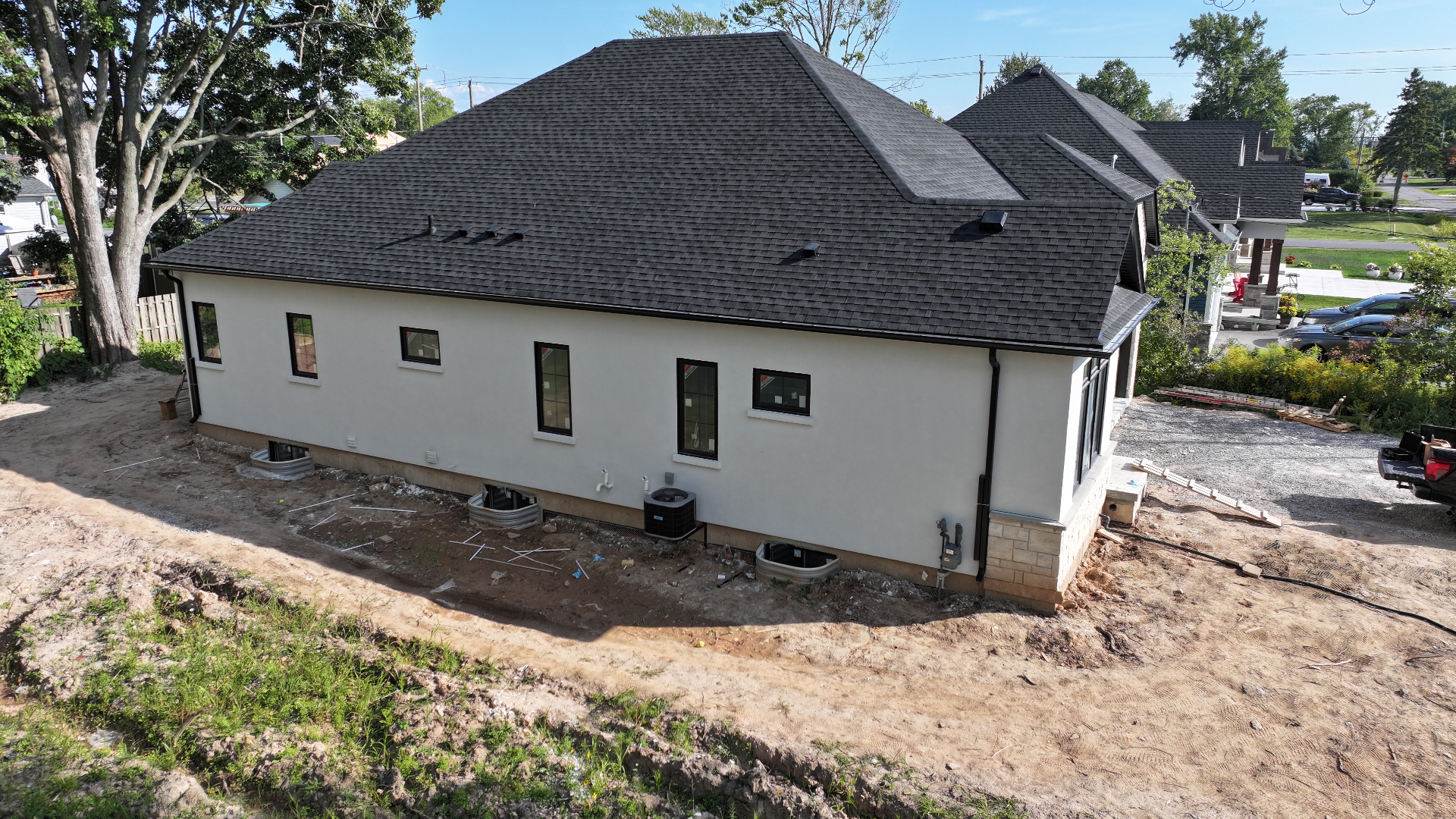 Side elevation showing smooth white stucco finish on a Niagara residential exterior