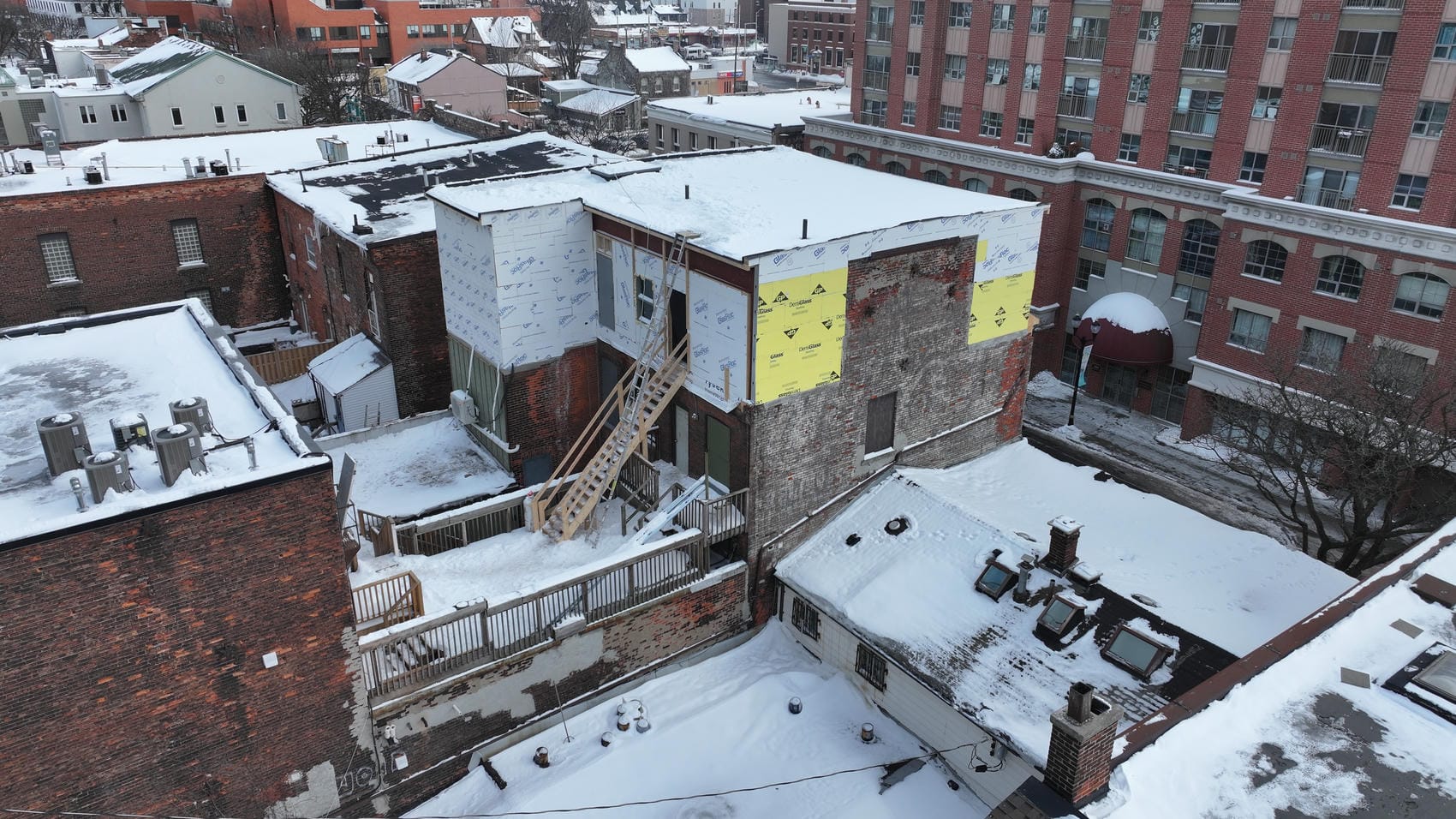 Early progress of four-storey commercial exterior renovation in Hamilton