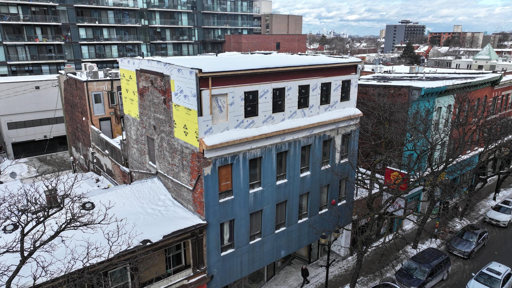 Front elevation sheathing progress on four-storey commercial building in Hamilton