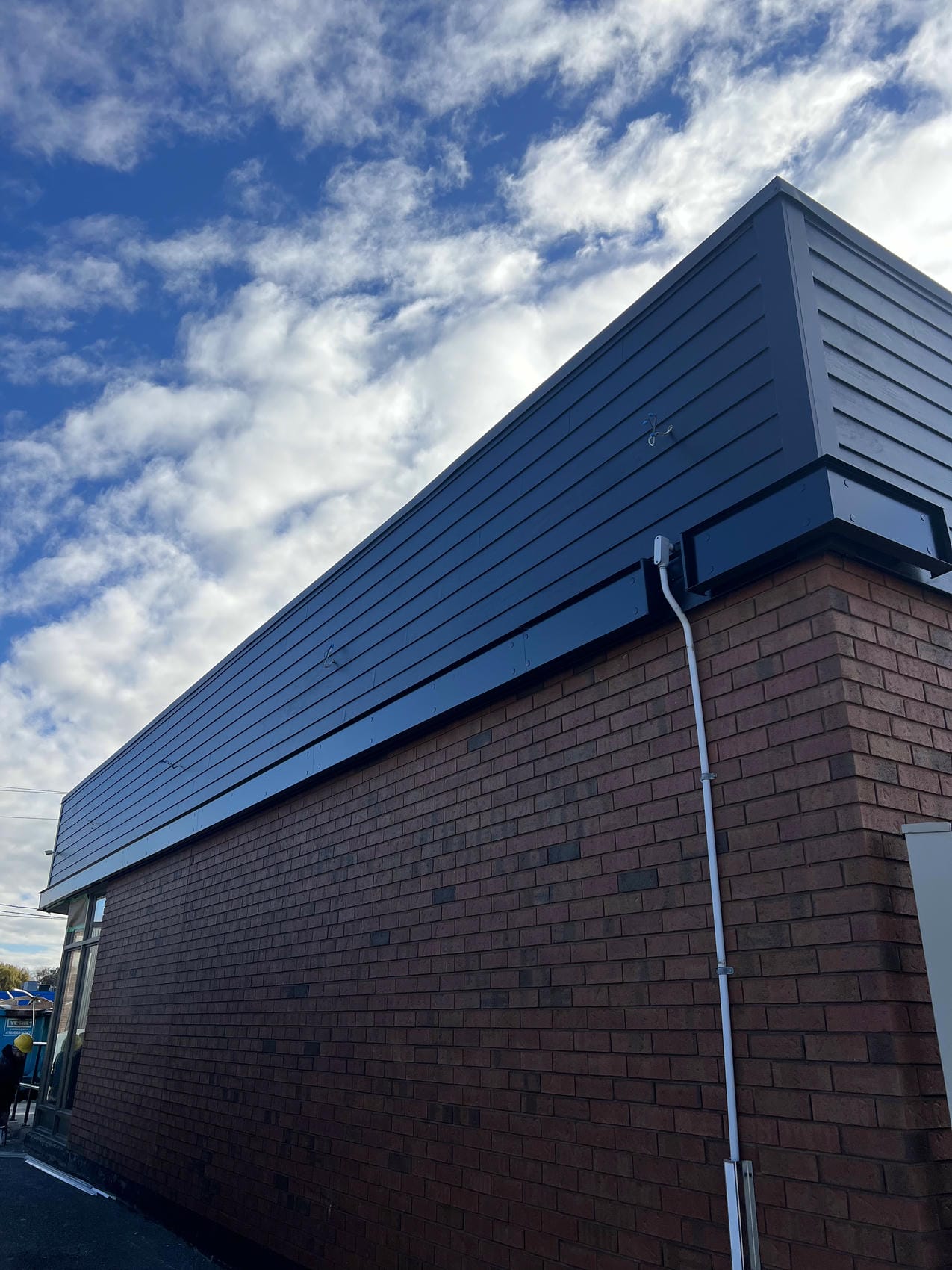 Commercial exterior cladding detail with black aluminum siding on Tim Hortons in Grimsby