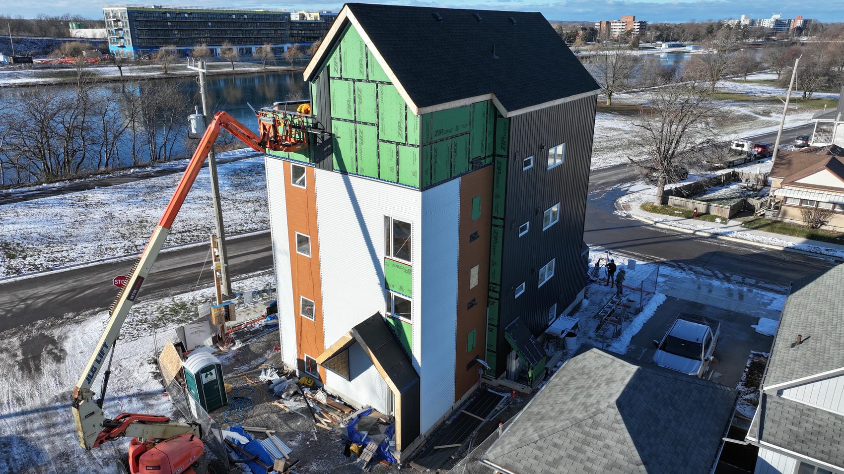 Commercial exterior cladding progress photo in Welland with black metal siding