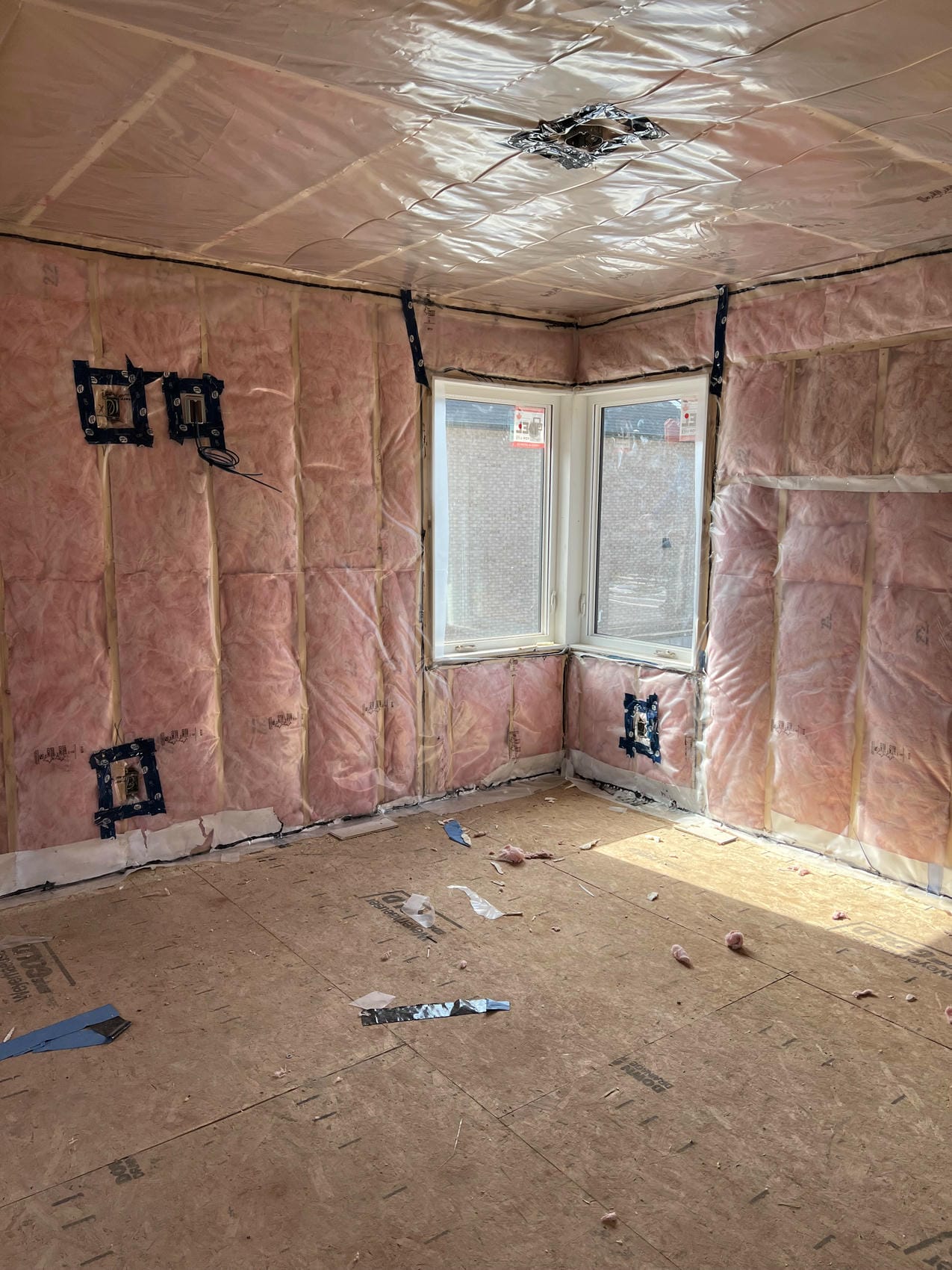 Batt insulation around bay window opening in Niagara interior renovation