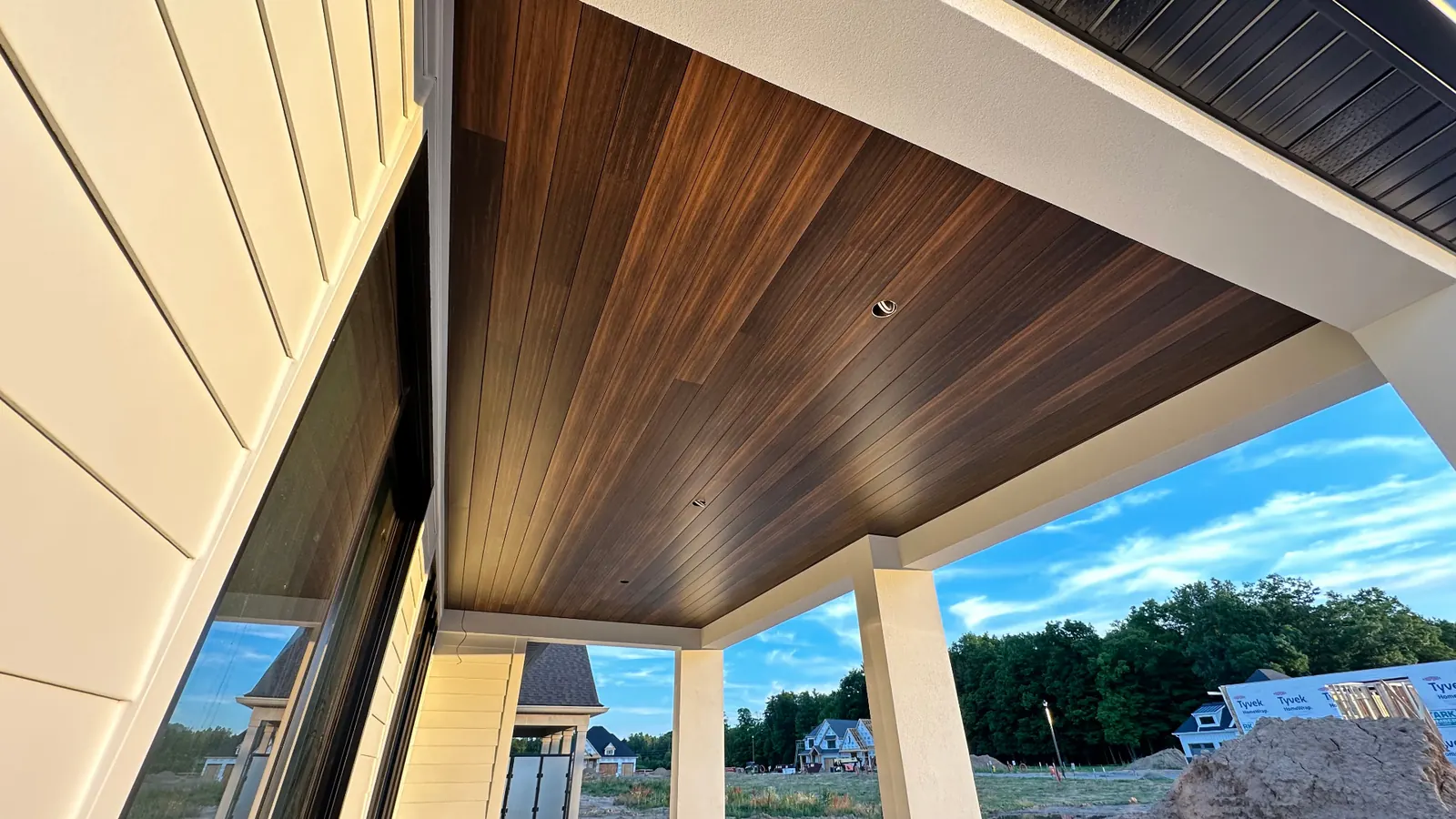 Aluminum porch soffit installation with wood-look ceiling finish