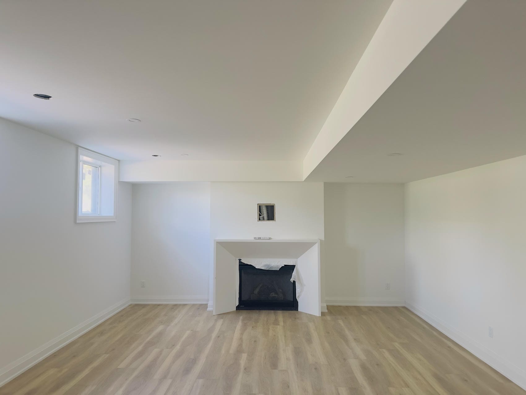 Finished basement living room with painted walls and ceiling in Niagara