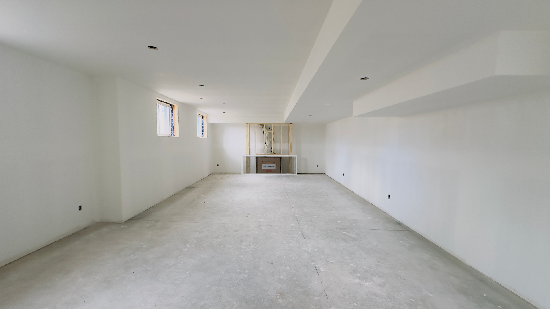 Basement renovation open drywalled living area in Niagara