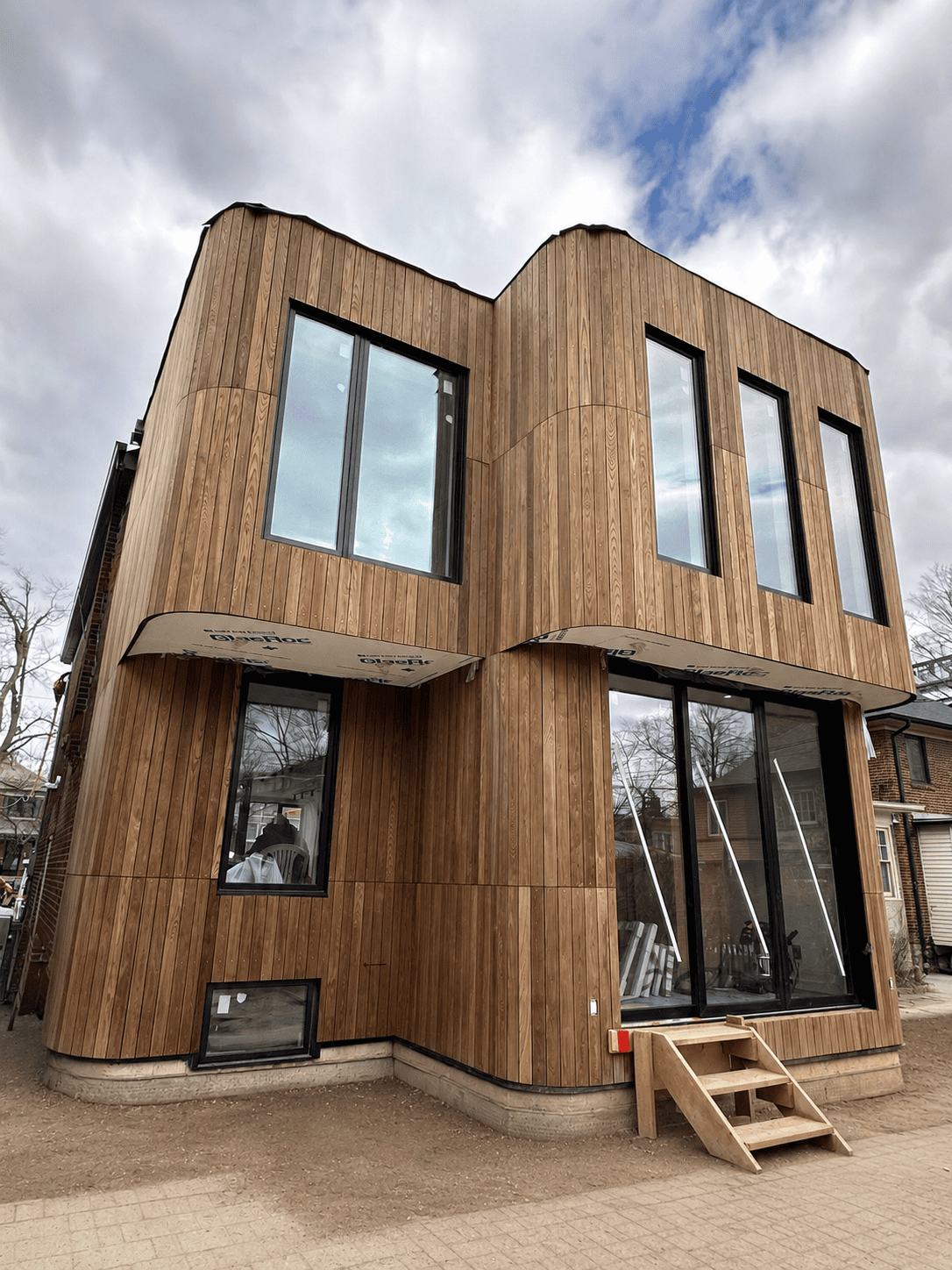Modern home with vertical cedar wood siding installed by Renovation Xperts