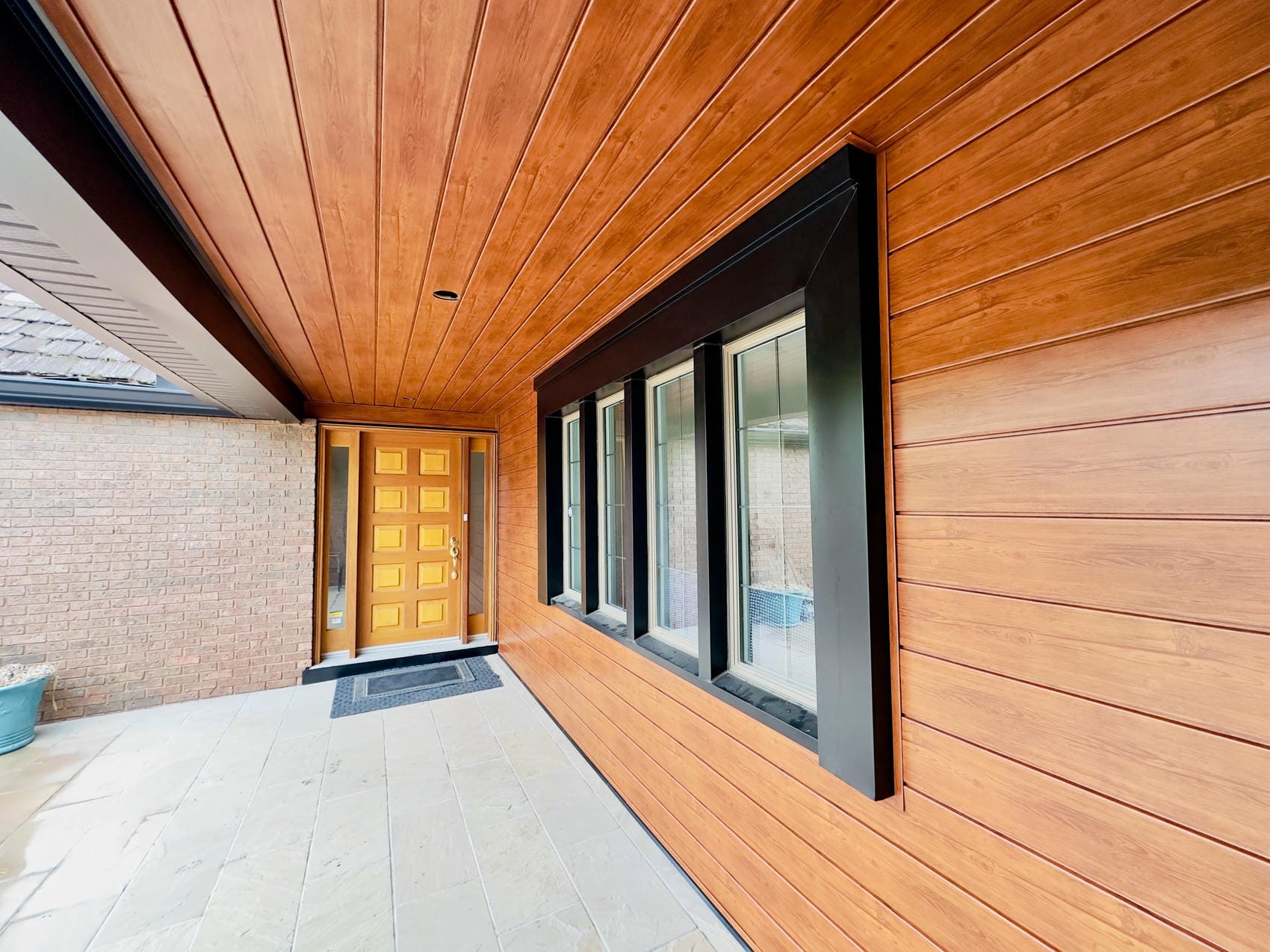Metal siding entryway with modern trim detailing in Niagara Region